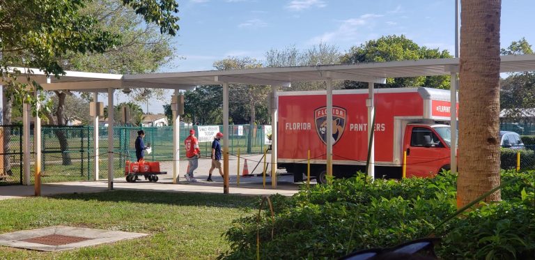 Florida Panthers truck parked beside a school's covered walkway