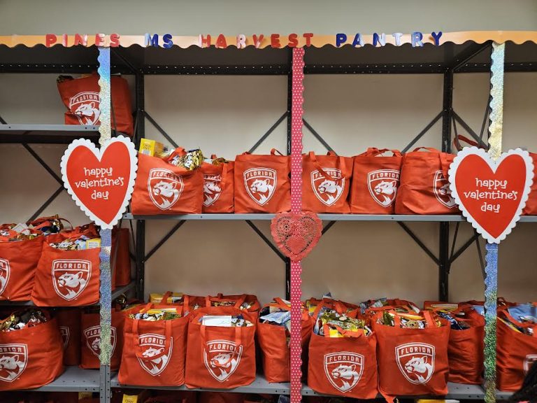 Shelves of red Florida Panthers tote bags decorated with Happy Valentine's Day hearts in a Harvest Pantry